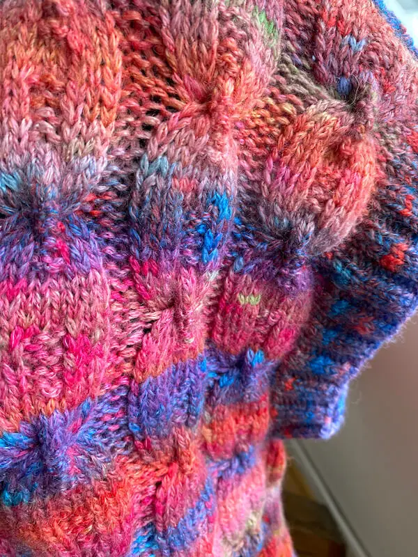 Gros plan sur les torsades du débardeur Bonny tricoté en Magnolia dégradé rose, violet et orange